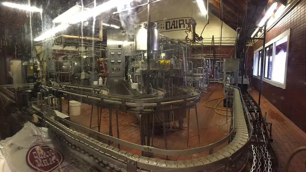 Packaging machinery running on a food production line inside a food manufacturing facility